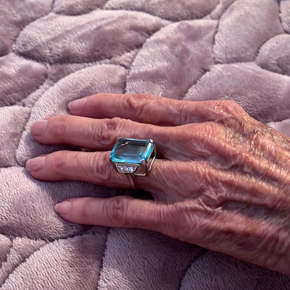 Blue topaz and sterling silver. Replica of ring prince harry gave to Megan!